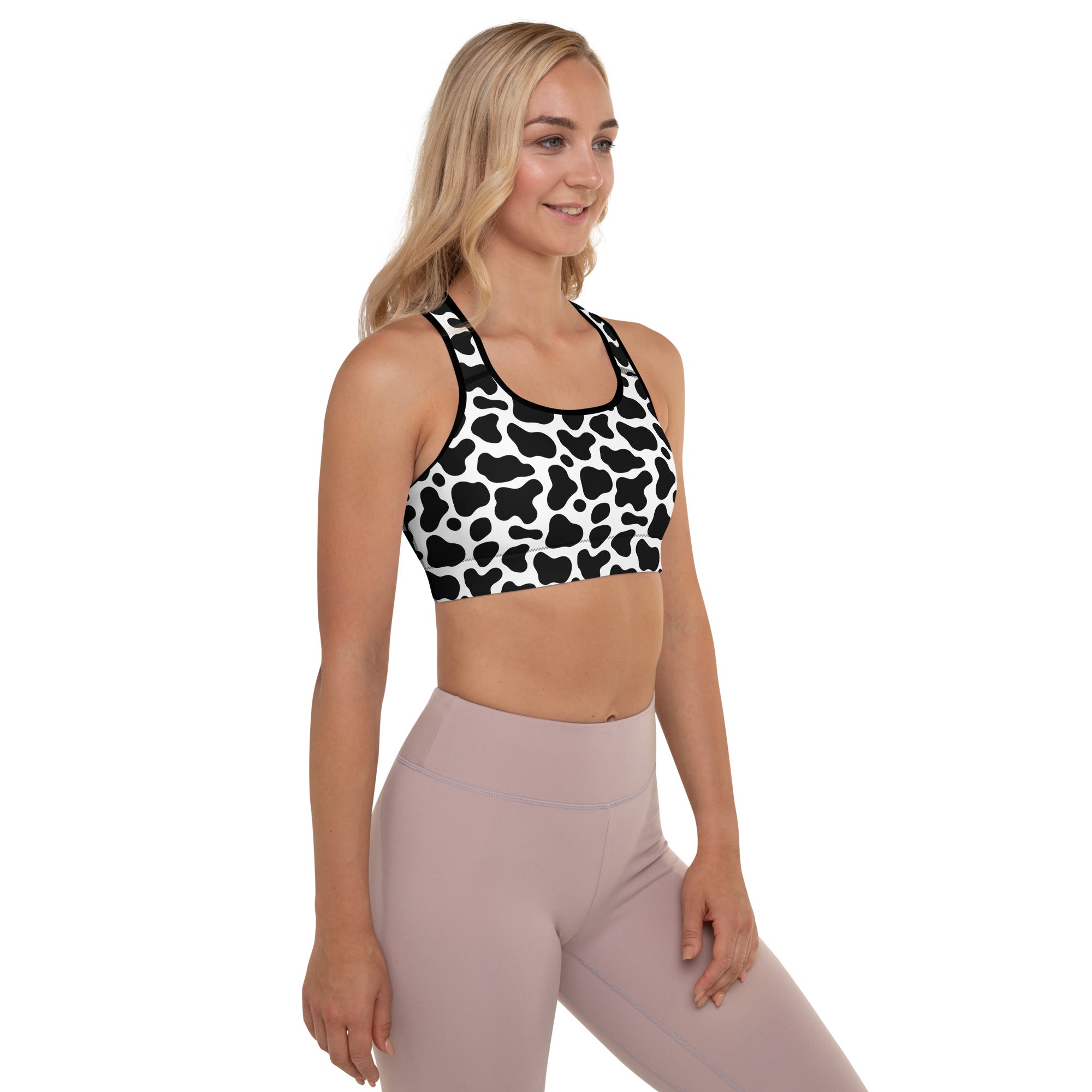 Women’s black and white cow print padded sports bra with buttery soft fabric supportive quick-dry material