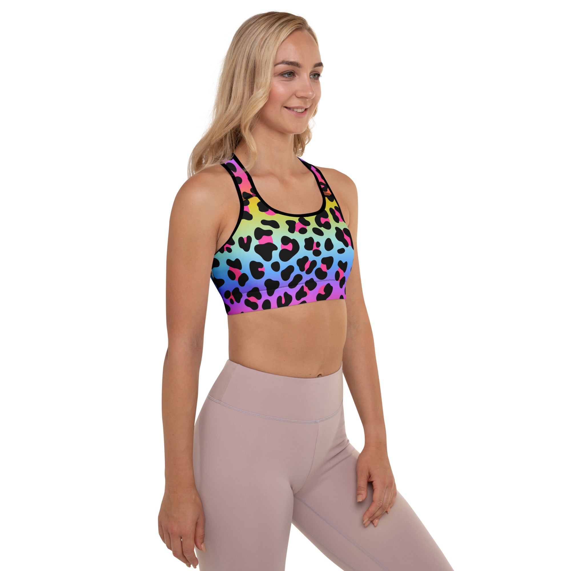 Women’s padded sports bra in vibrant rainbow leopard print with black and pink accents, buttery soft and quick-dry