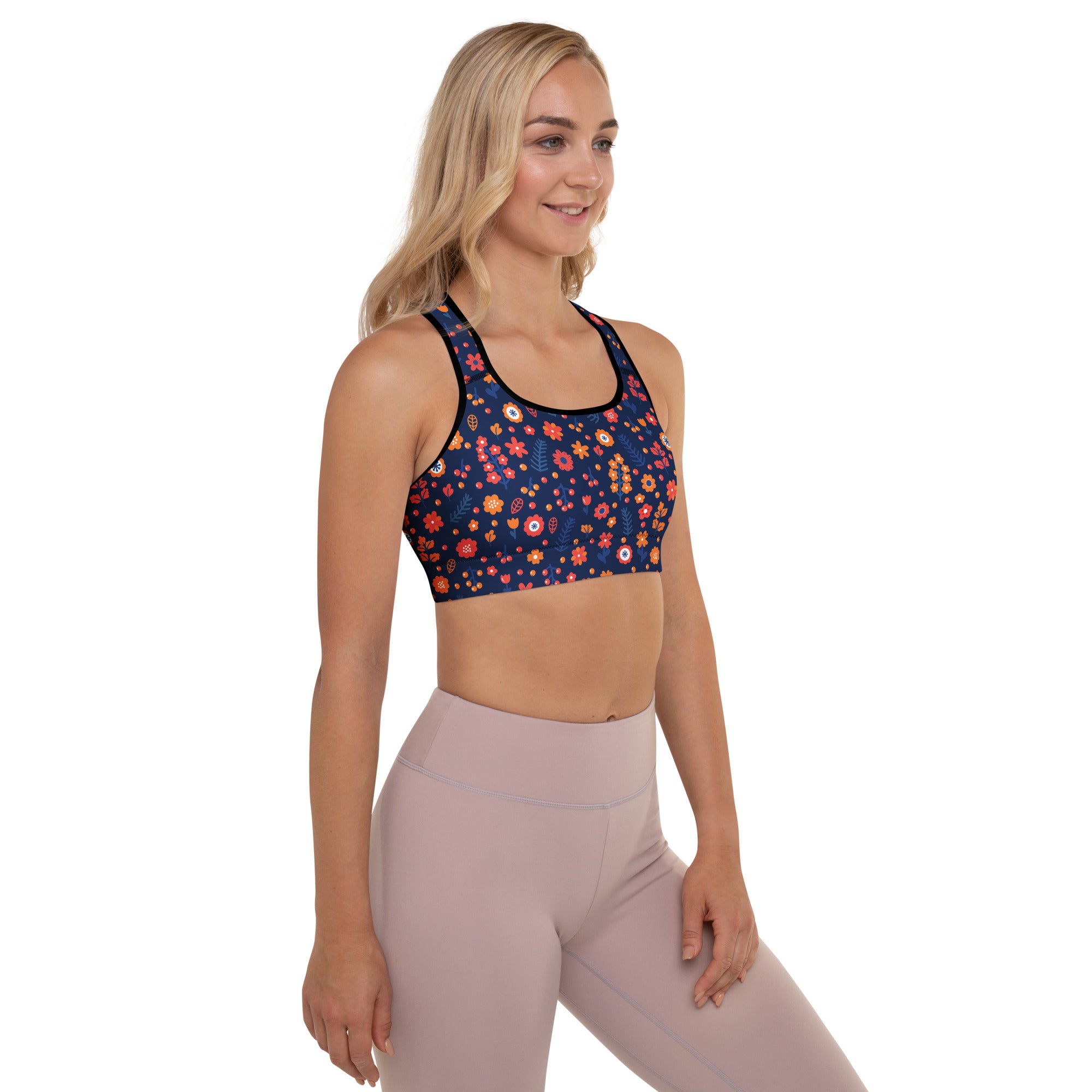 A navy floral padded sports bra with vibrant orange pink and yellow blossoms buttery soft and quick-dry