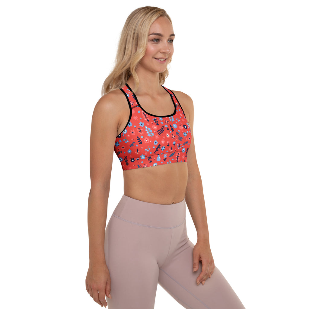 Women’s red floral padded sports bra with black trim, buttery soft fabric, supportive fit, and quick-dry technology