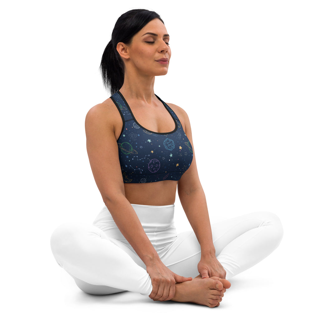 Dark blue space-themed women’s padded sports bra with celestial patterns black trim buttery soft and quick dry