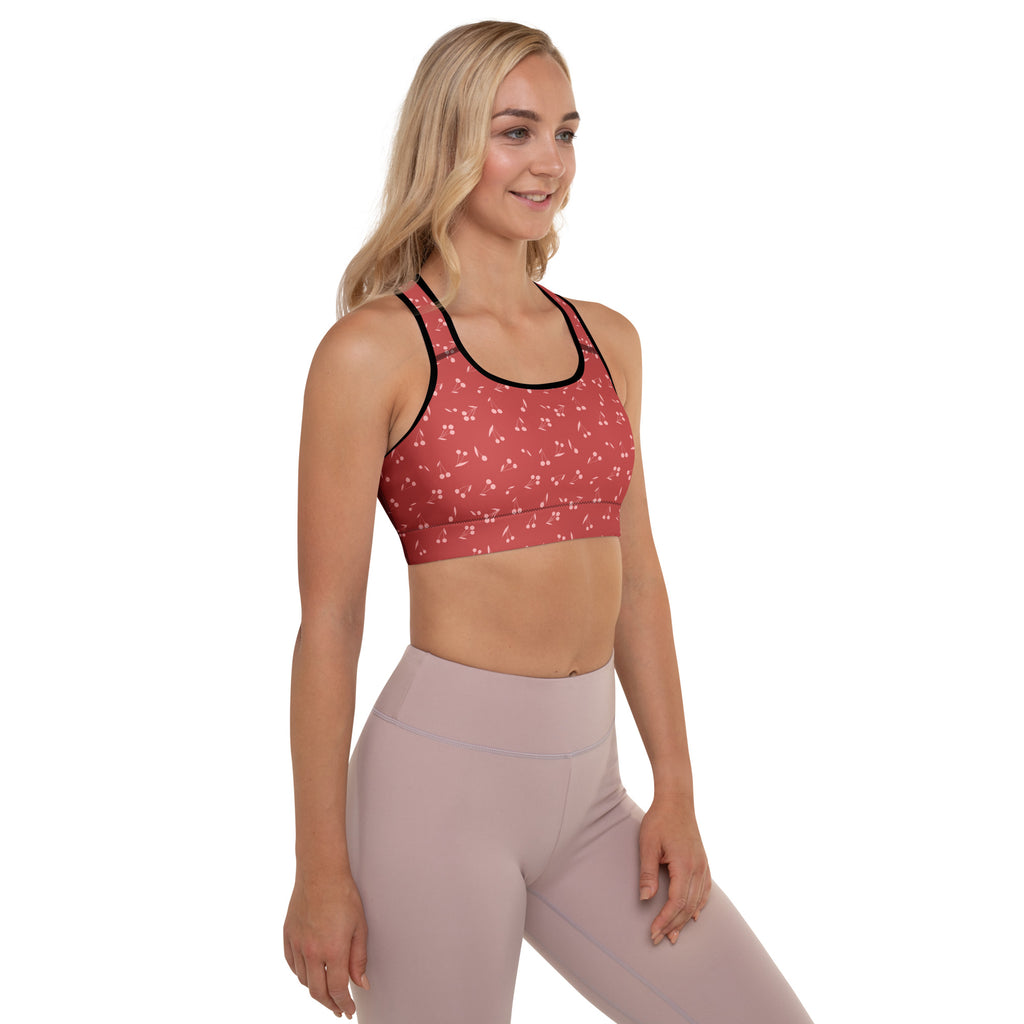 Women’s cherry print padded sports bra in red with black trim and subtle white pattern, buttery soft and quick-dry