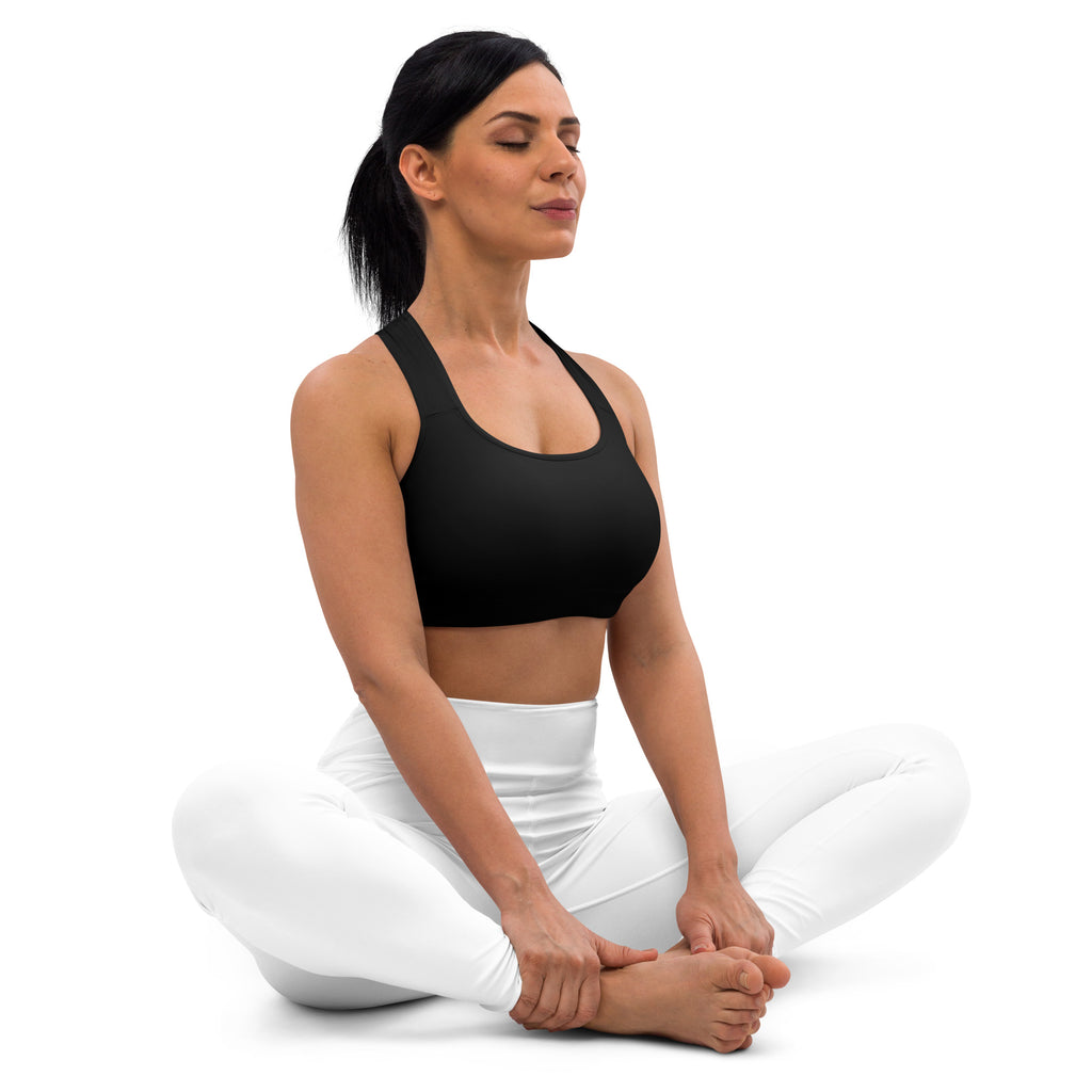 Women’s black padded sports bra with racerback straps and scoop neckline paired with white high waisted leggings