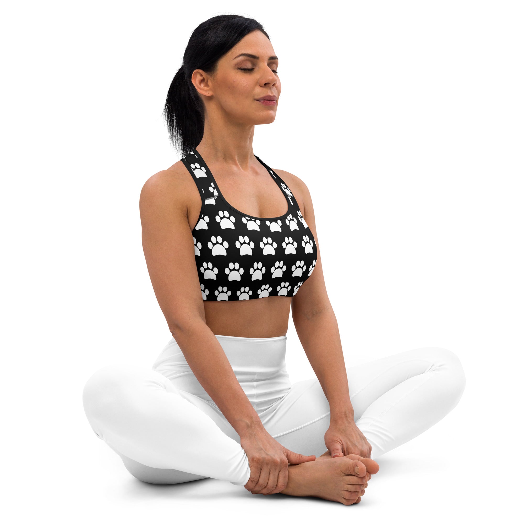Women’s black padded sports bra with white paw print pattern, buttery soft, supportive, and quick-dry fabric