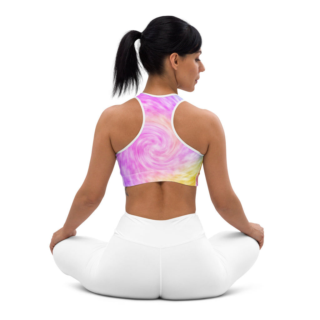 A vibrant women’s rainbow tie dye padded sports bra with swirling pink purple yellow hues buttery soft supportive and quick dry