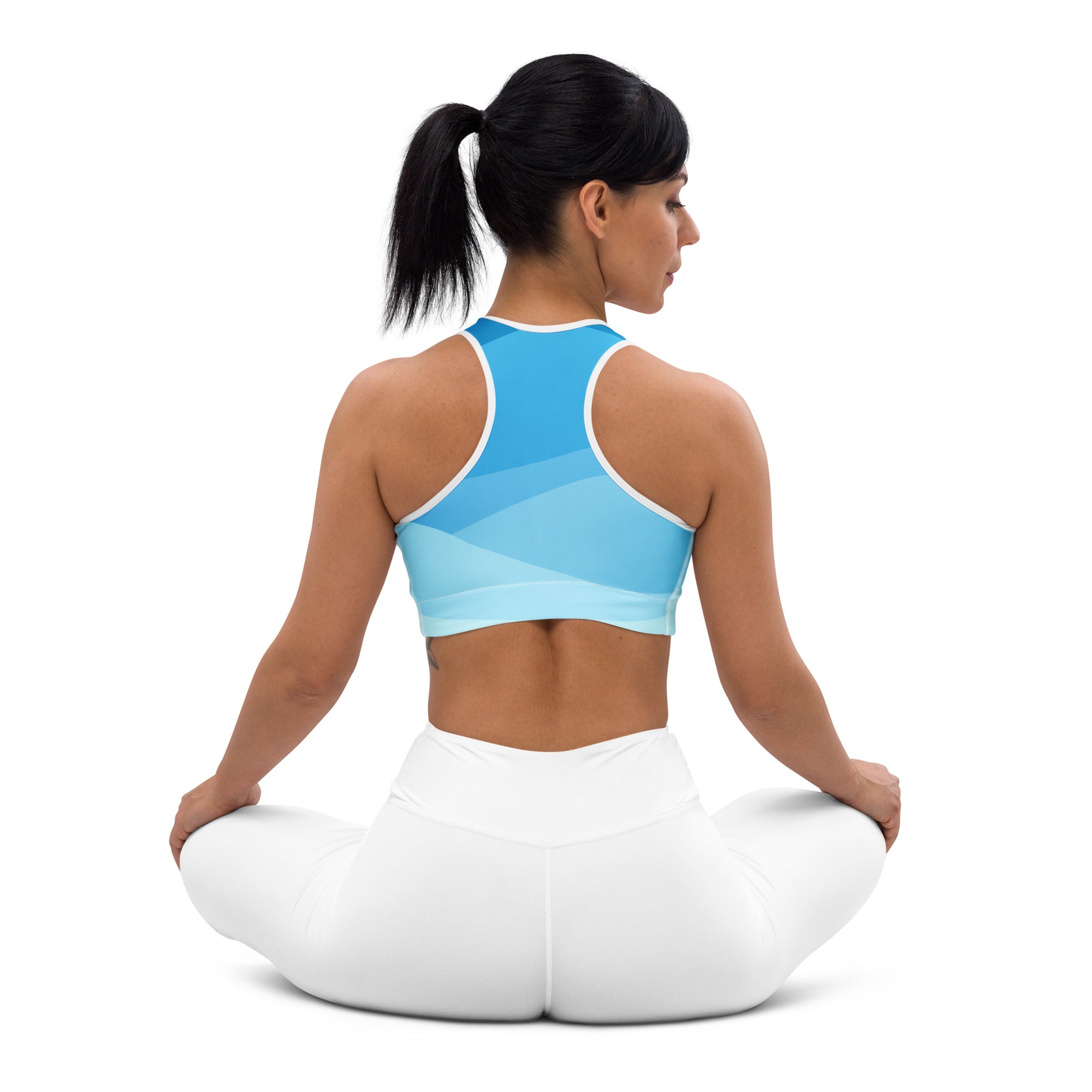 Women’s blue waves padded sports bra in light blue gradient with white trim and racerback design, buttery soft and quick-dry
