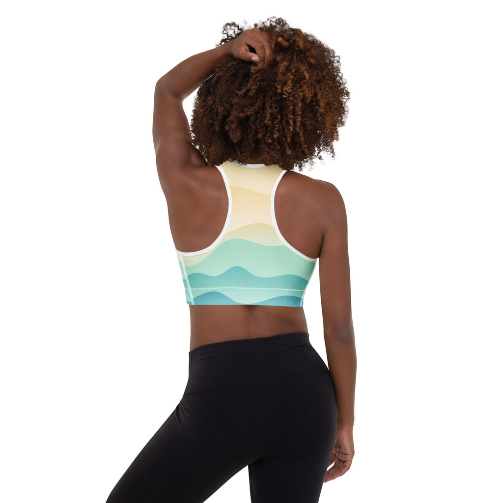 A woman wearing a pastel ocean wave padded sports bra with white straps in buttery soft quick-dry fabric