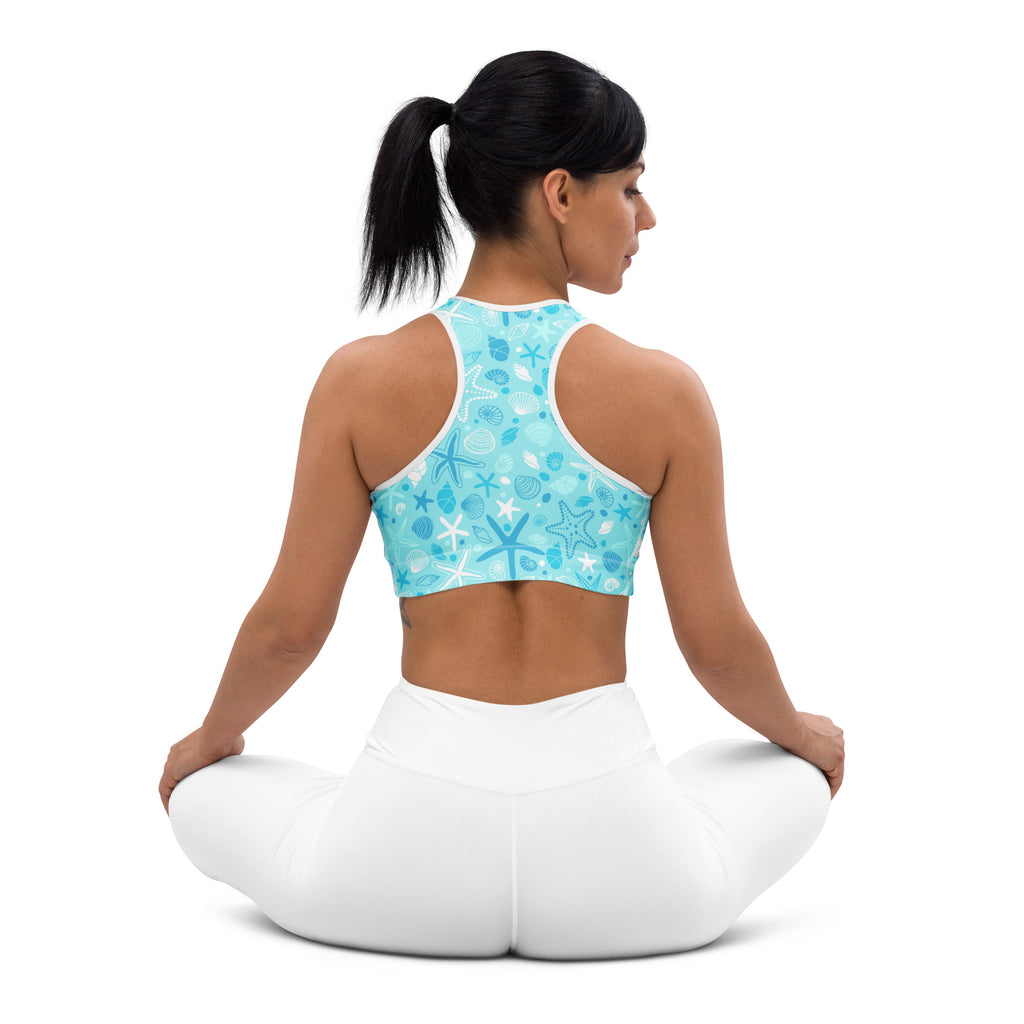 Women’s light blue padded sports bra with white starfish and shells pattern and supportive racerback straps