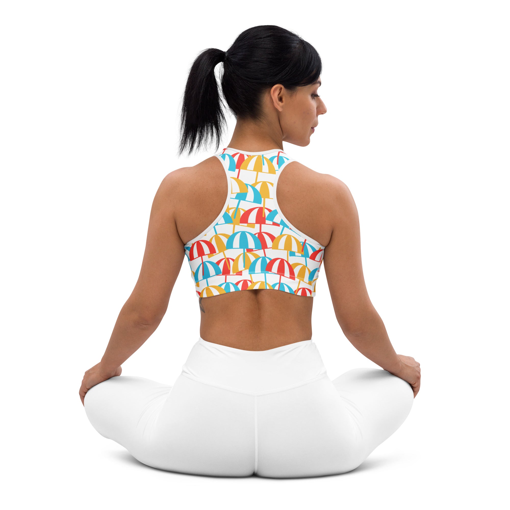 A vibrant women’s beach umbrella padded sports bra with multicolored umbrella pattern on white quick-dry fabric