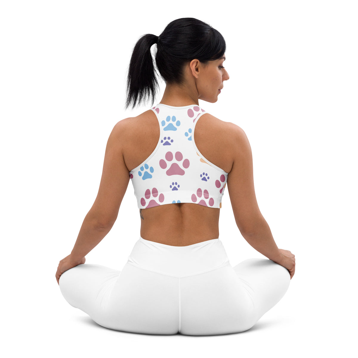 White padded sports bra with colorful pink and blue paw print pattern, buttery soft, supportive, and quick-dry