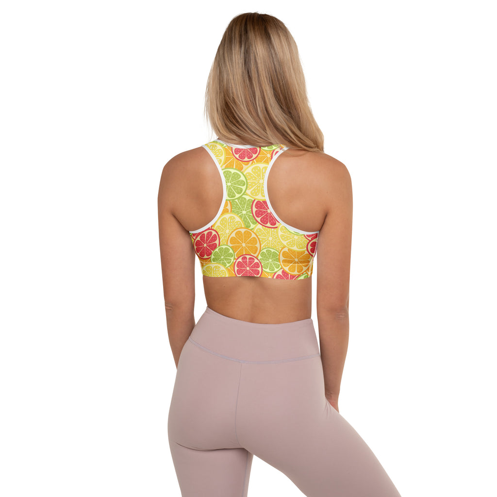A vibrant yellow women’s citrus slice padded sports bra with playful sliced fruit pattern, buttery soft and quick-dry