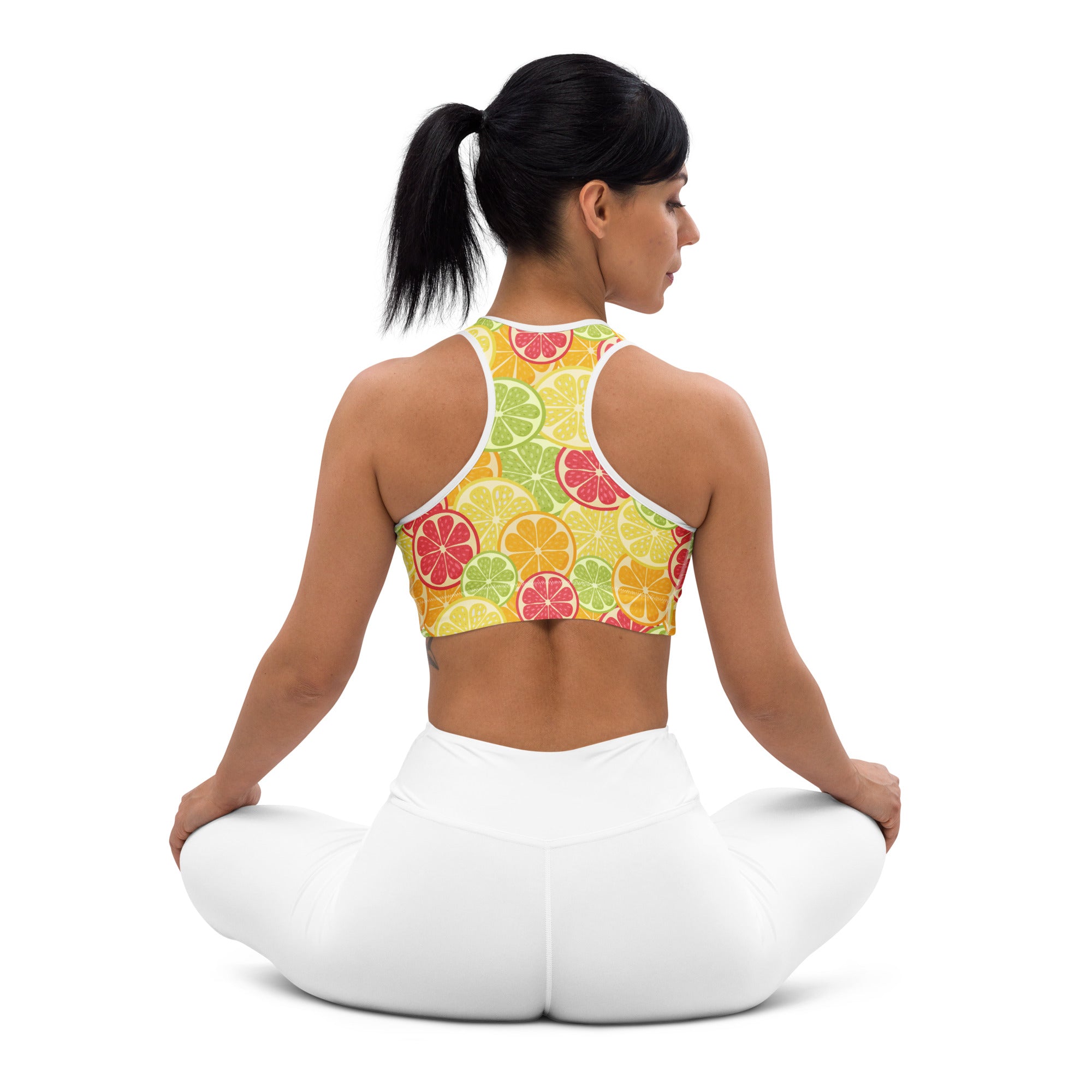 Women’s citrus slice padded sports bra with vibrant grapefruit lime and orange print in bright yellow green and red hues