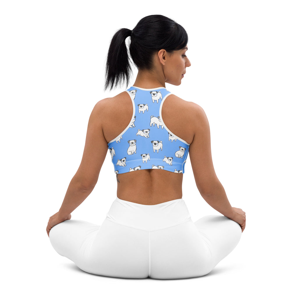 Women’s blue padded sports bra with white pug illustrations and white trim, buttery soft, supportive, and quick-dry