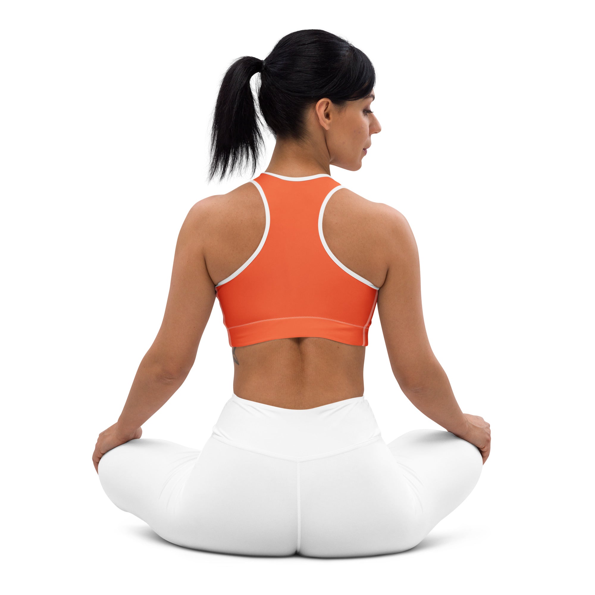 Women’s orange padded sports bra with white trim buttery soft supportive and quick-dry material for workouts