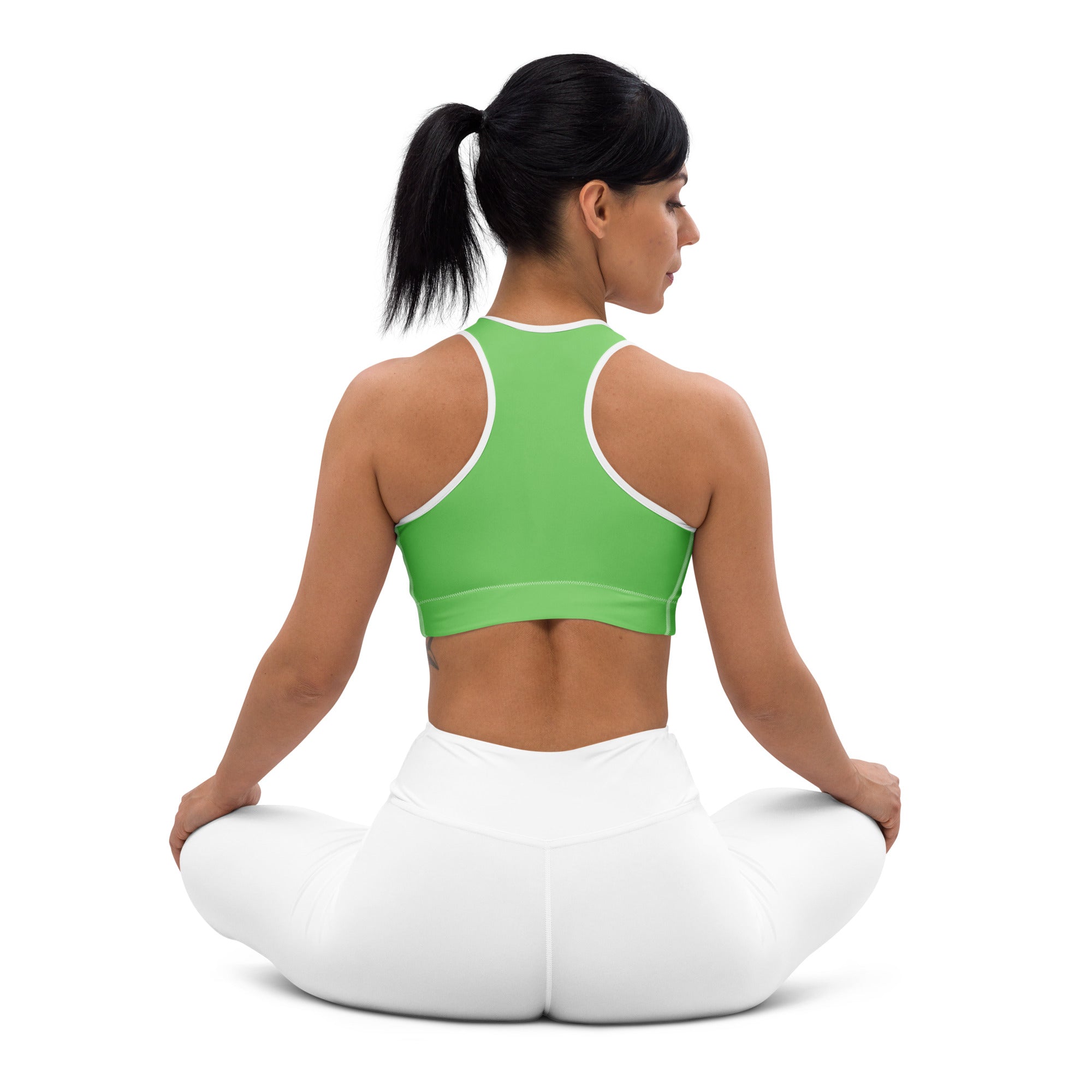 A vibrant green padded sports bra with white trim and racerback made from buttery soft supportive quick-dry fabric