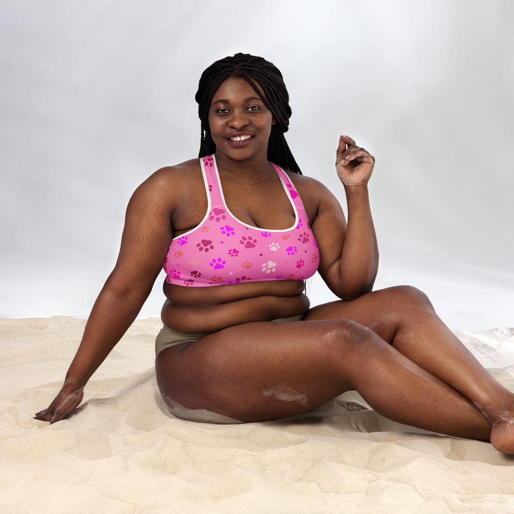 Women’s pink paw print padded sports bra with purple and white pattern, buttery soft, supportive, and quick-dry material