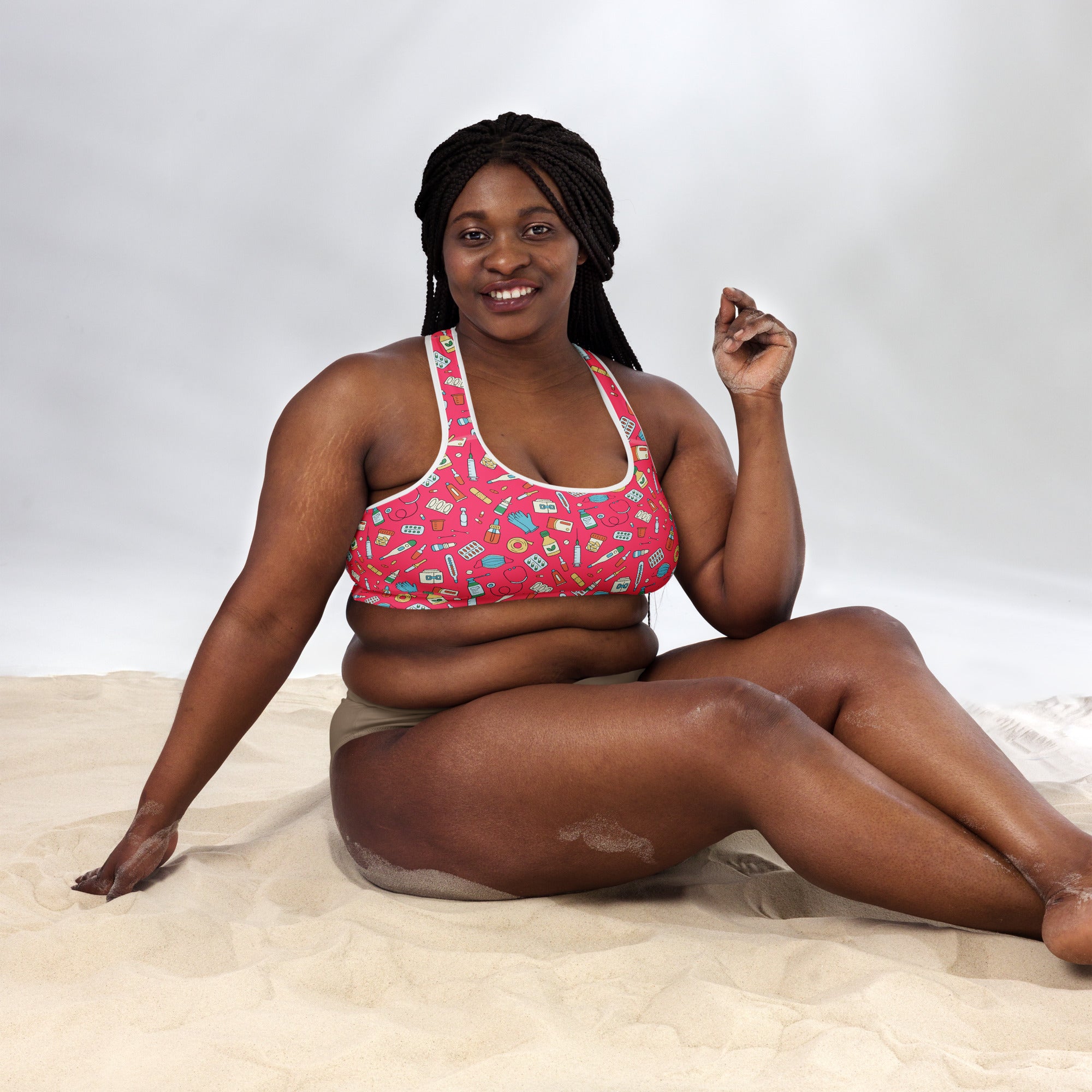Women’s nurse padded sports bra in pink with white trim featuring colorful makeup patterns, buttery soft and quick-dry