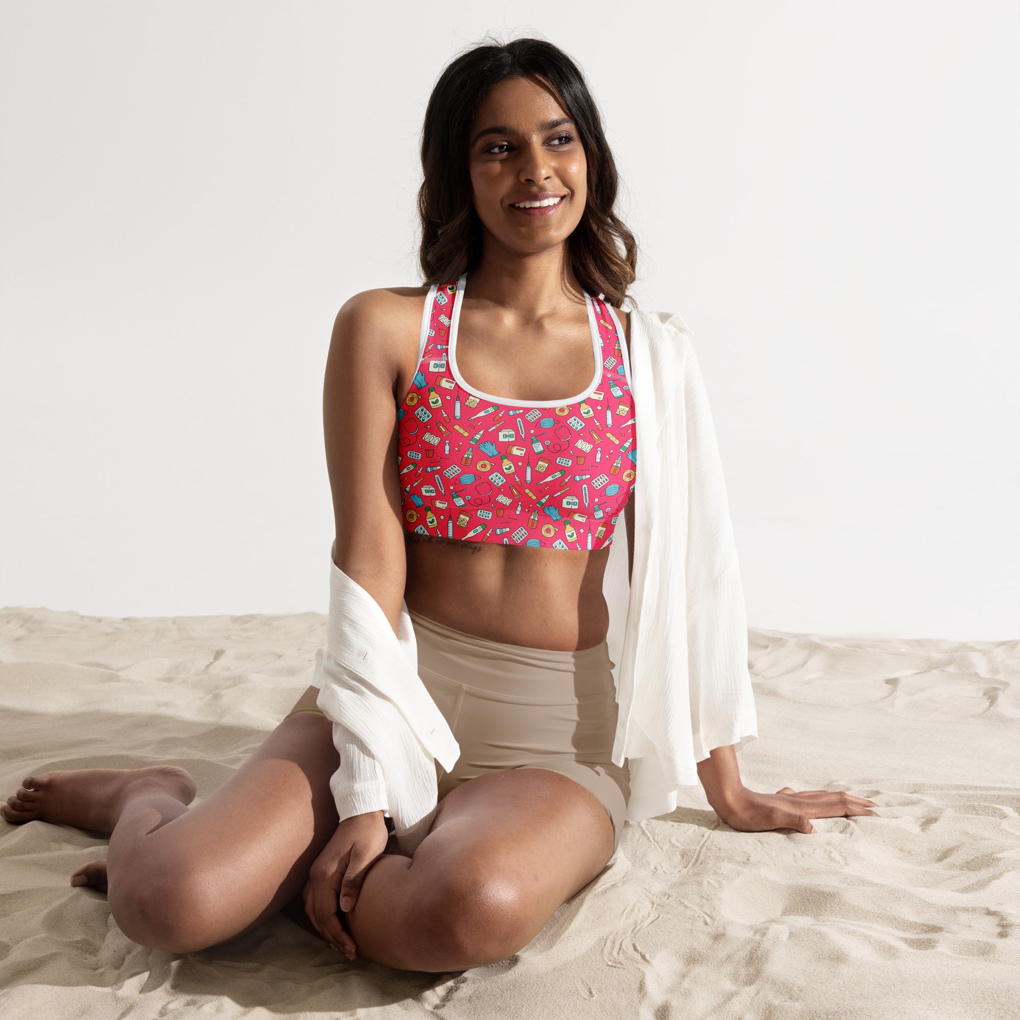 Women’s nurse padded sports bra in pink with white trim featuring colorful school supplies pattern buttery soft and quick-dry