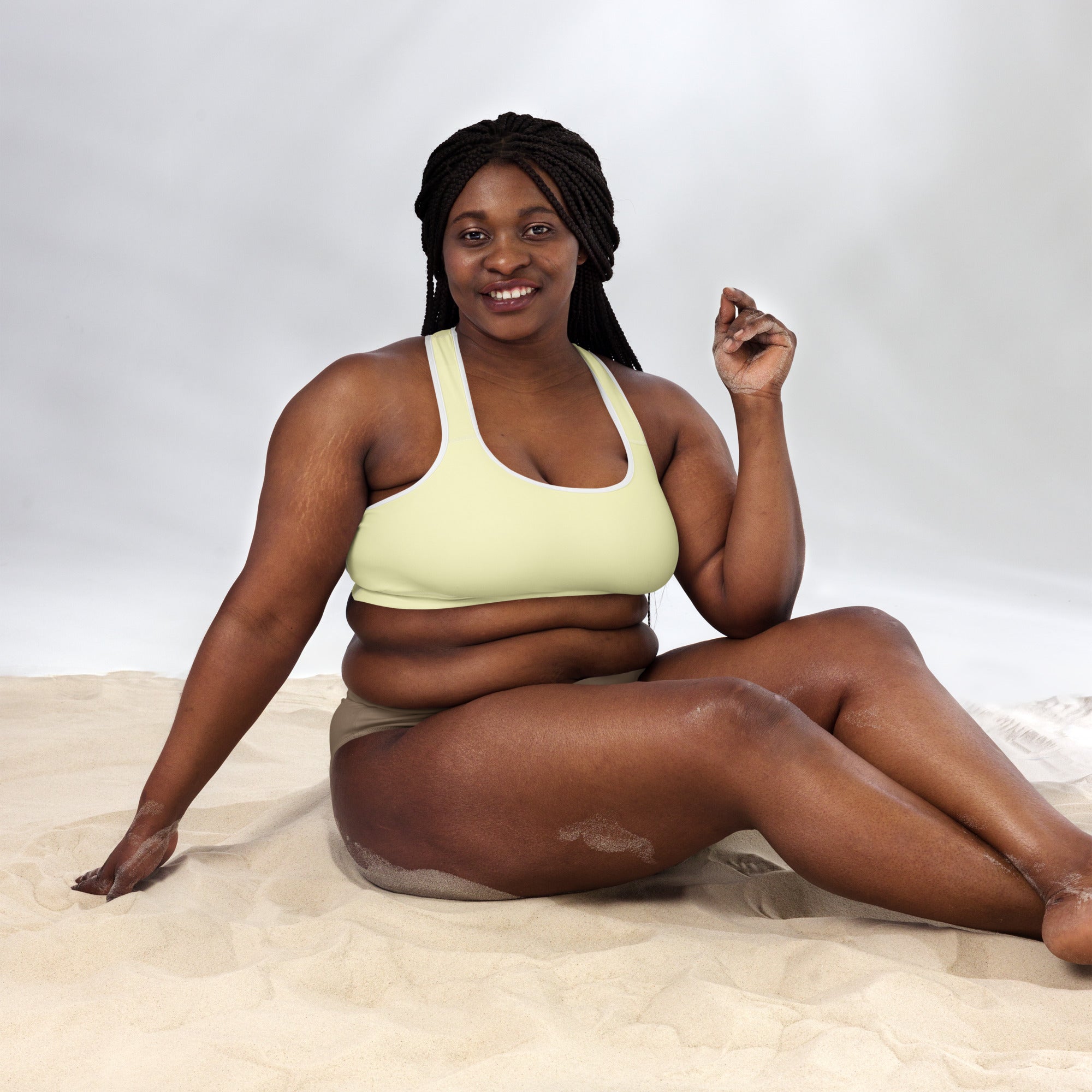 A woman wearing a light green strap-style sports bra made of buttery soft, supportive, quick-dry fabric