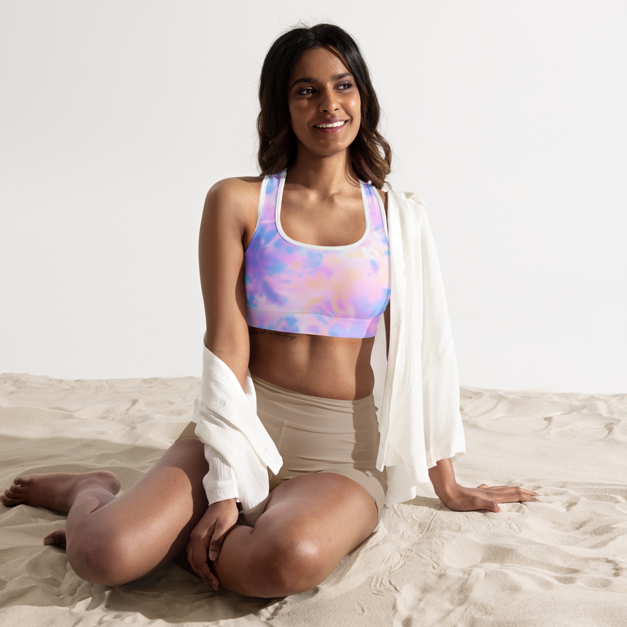 Pastel tie-dye women’s padded sports bra with racerback design made of buttery soft quick-dry fabric shown from back