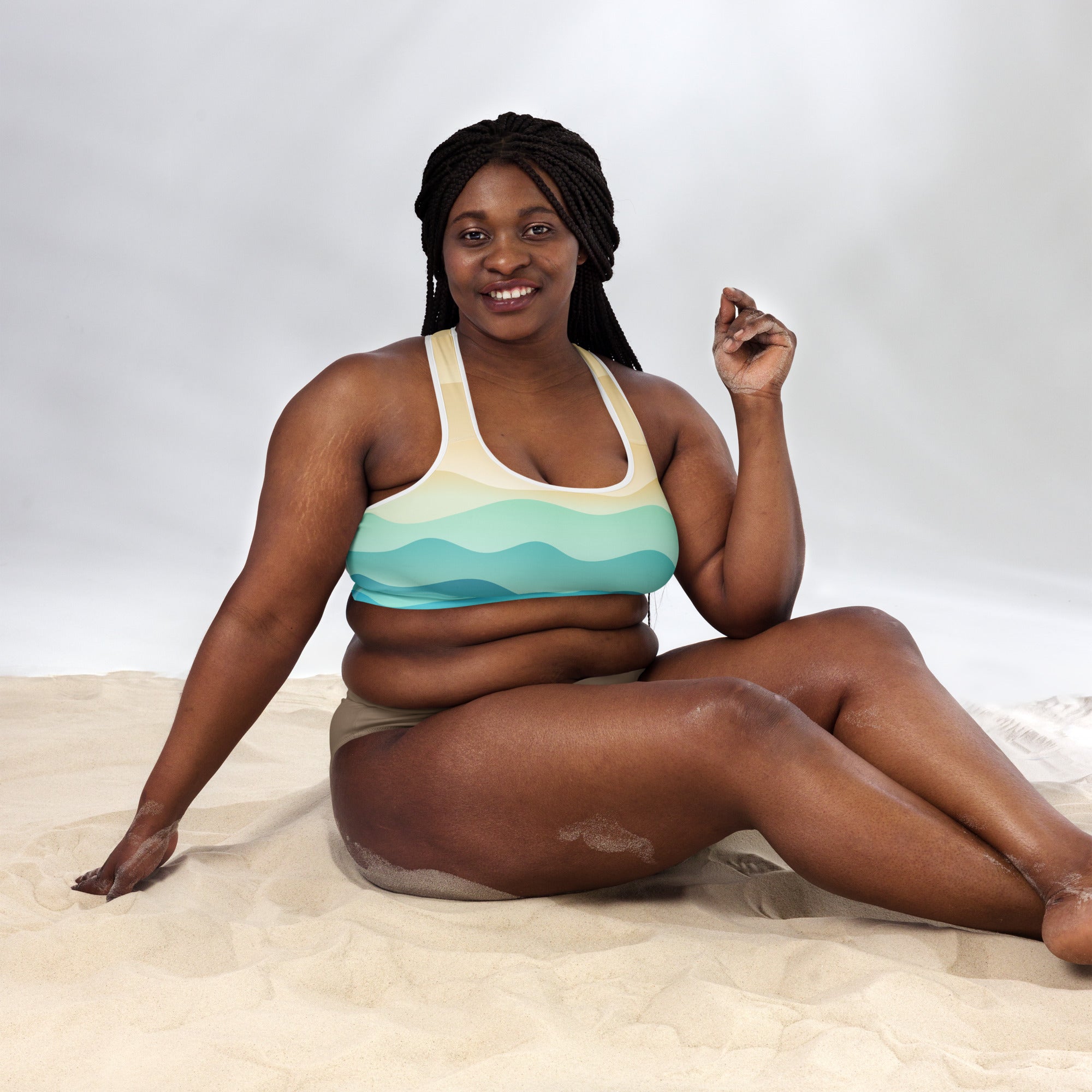 A woman wearing a beige and teal pastel ocean wave padded sports bra with quick-dry supportive fabric
