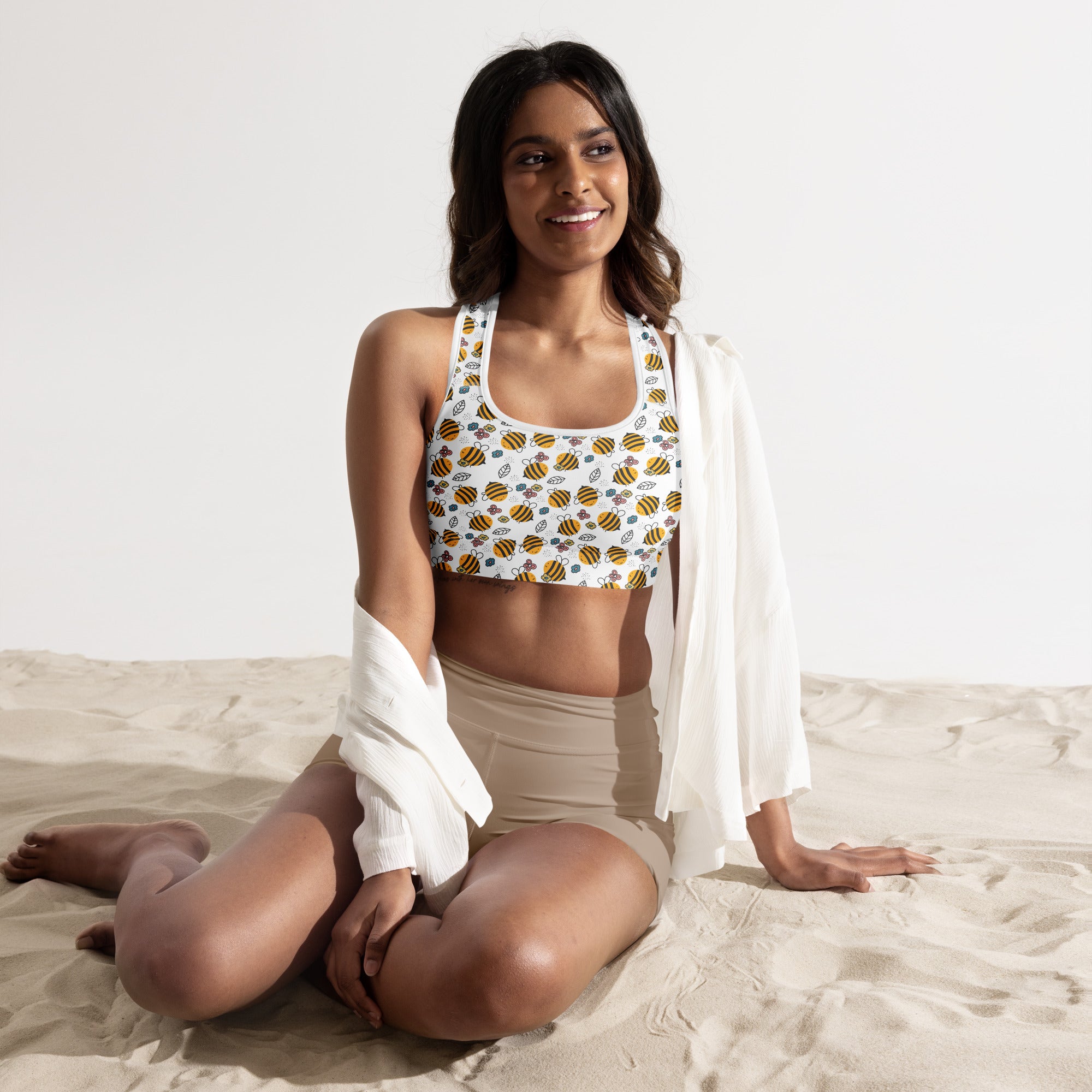 White women’s sports bra with yellow and black bumblebee pattern, padded, buttery soft, supportive, and quick-dry material