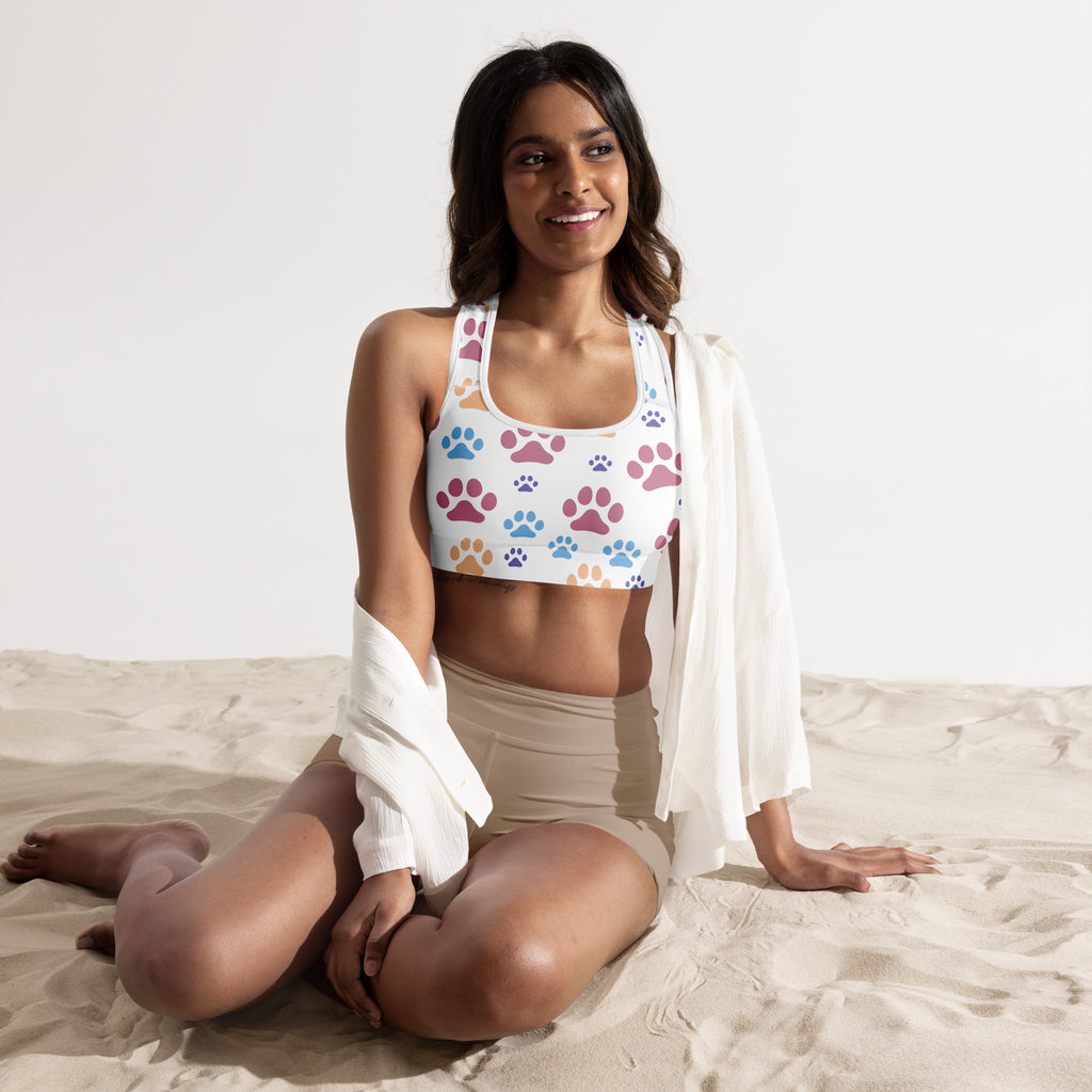 White padded sports bra with colorful pink purple and blue paw prints buttery soft supportive quick-dry design