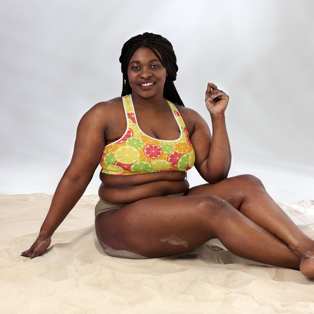 A vibrant yellow women’s citrus slice padded sports bra with playful citrus pattern, buttery soft and quick-dry fabric