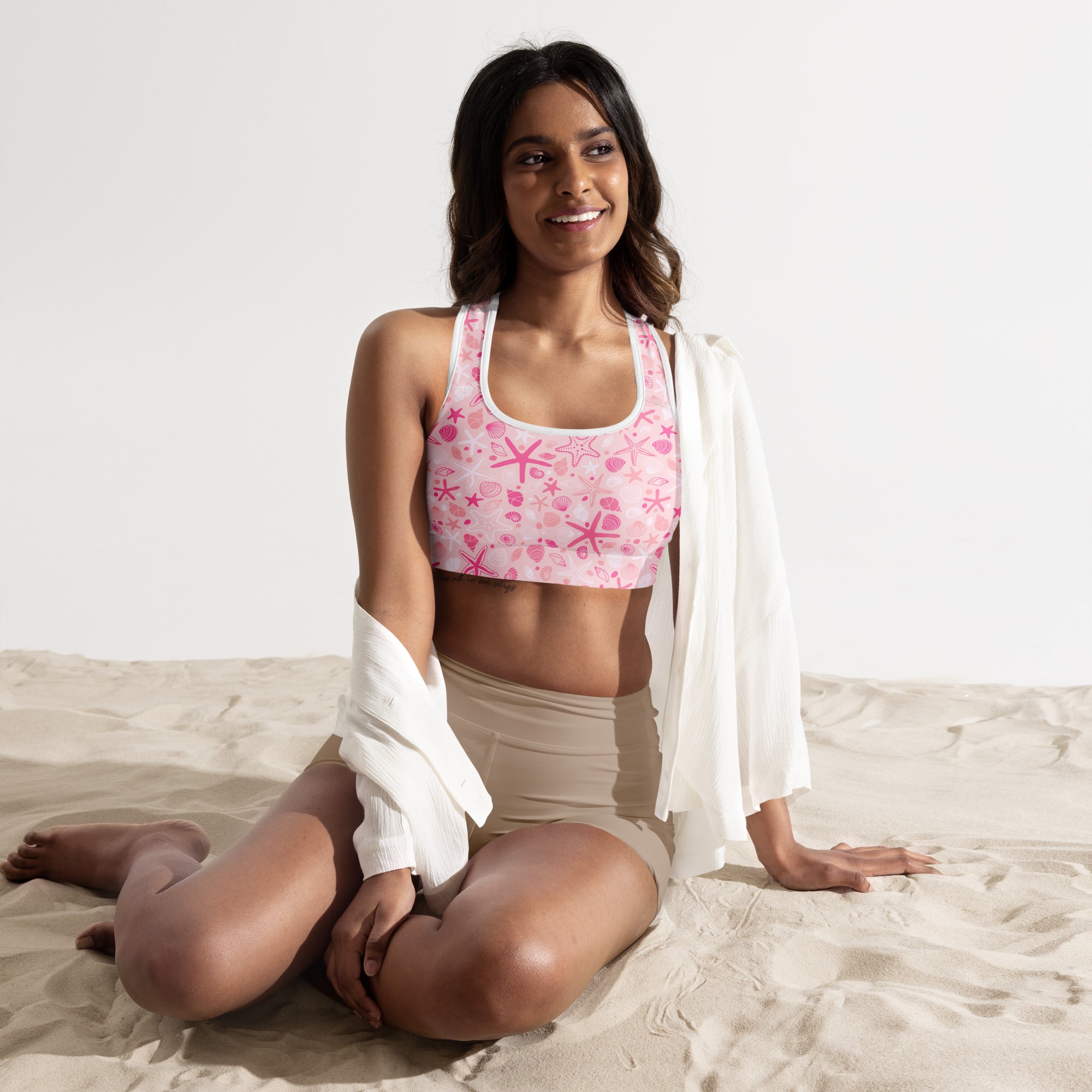Women’s pink starfish and seashell patterned padded sports bra made of buttery soft, supportive, quick-dry fabric