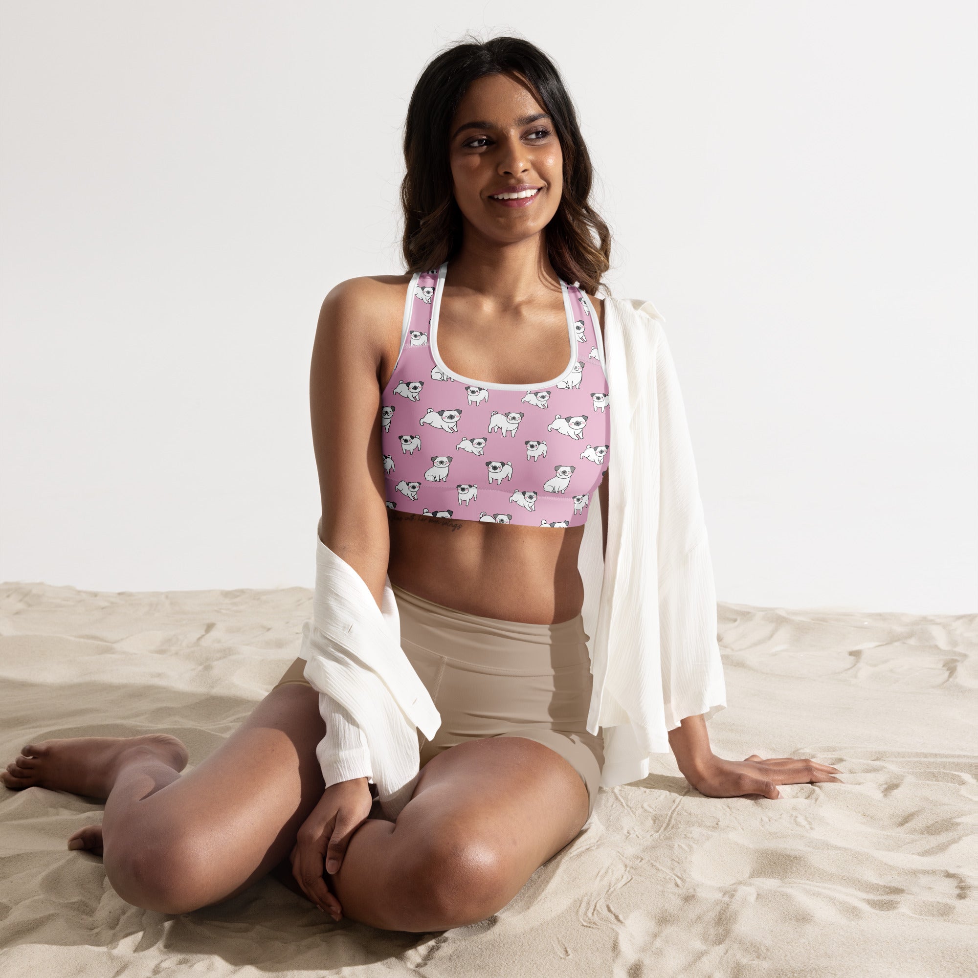 Women’s pink pug padded sports bra with white trim featuring cartoon pug pattern buttery soft supportive and quick-dry