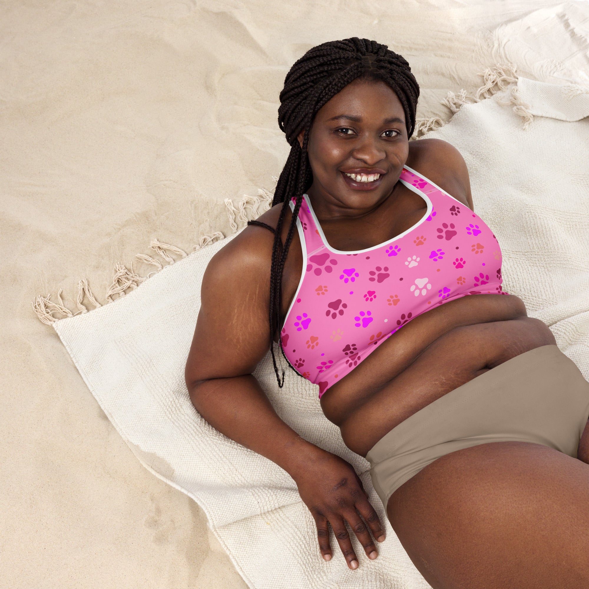 Women’s pink paw print padded sports bra with white trim featuring purple pink and orange paw prints quick-dry and supportive