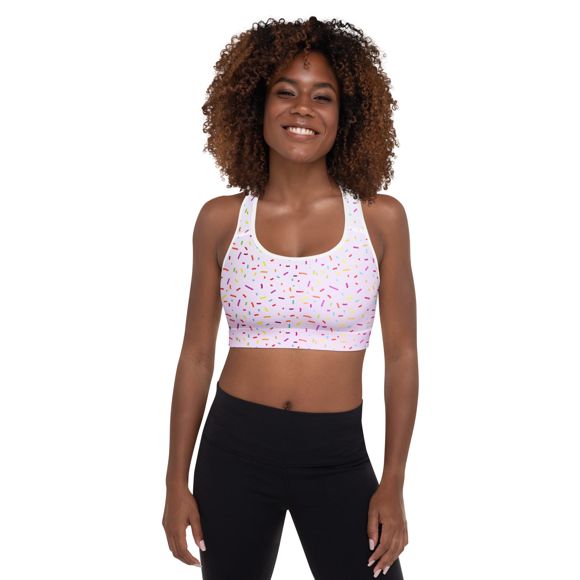 White padded sports bra with colorful sprinkle pattern, buttery soft fabric, supportive fit, and quick-dry material