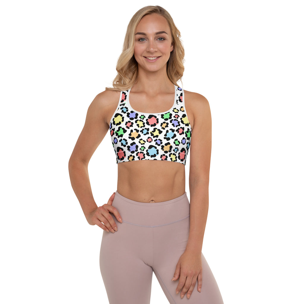 A white sports bra with vibrant multicolored leopard print and black outlines made of buttery soft quick-dry fabric