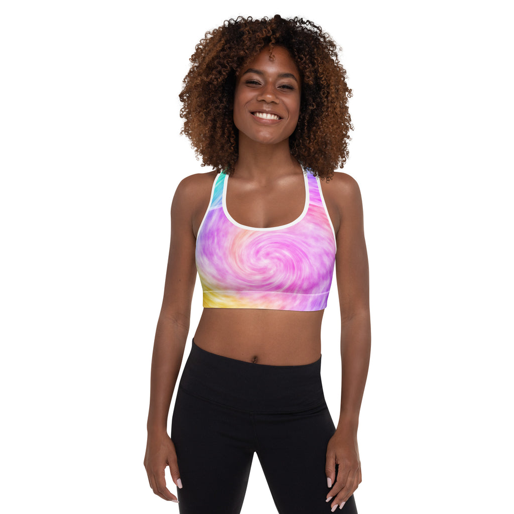 A vibrant rainbow tie dye padded sports bra with white trim and racerback design, buttery soft and quick dry