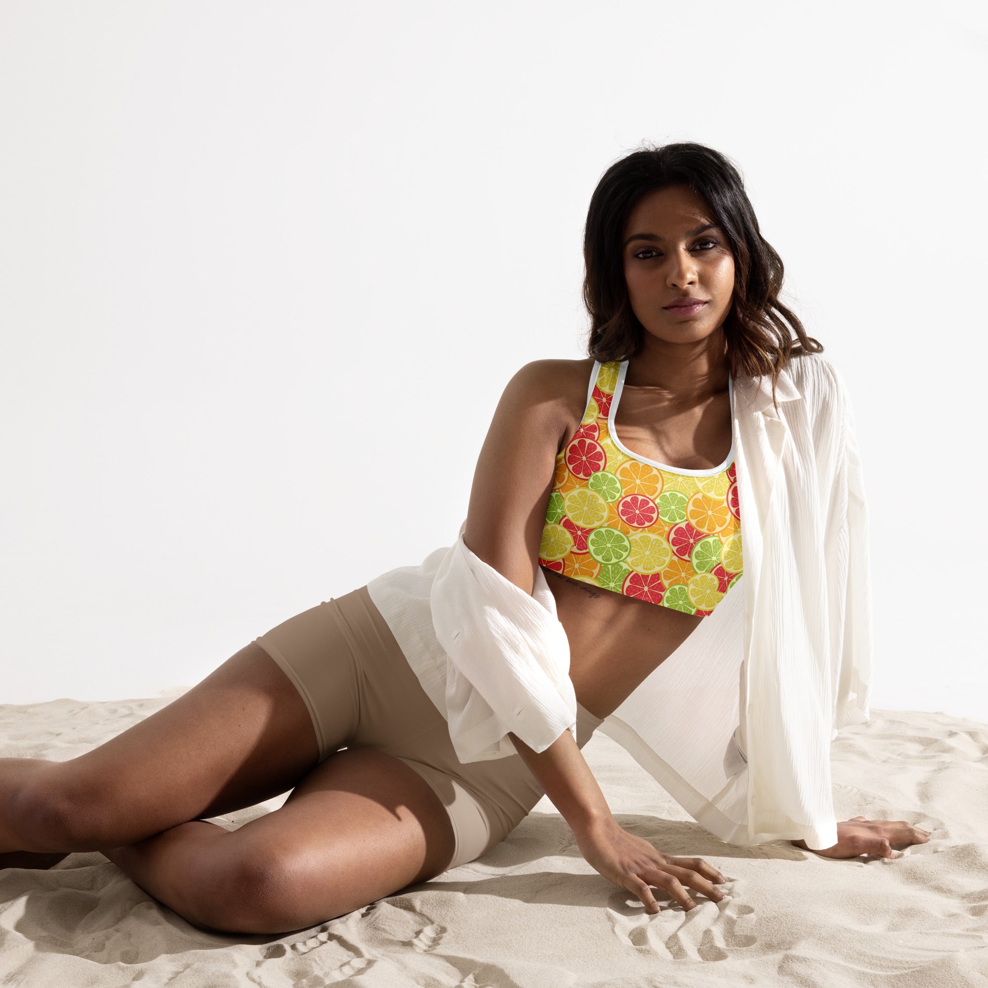 A vibrant yellow women’s citrus slice padded sports bra with playful citrus pattern, buttery soft, supportive, and quick-dry