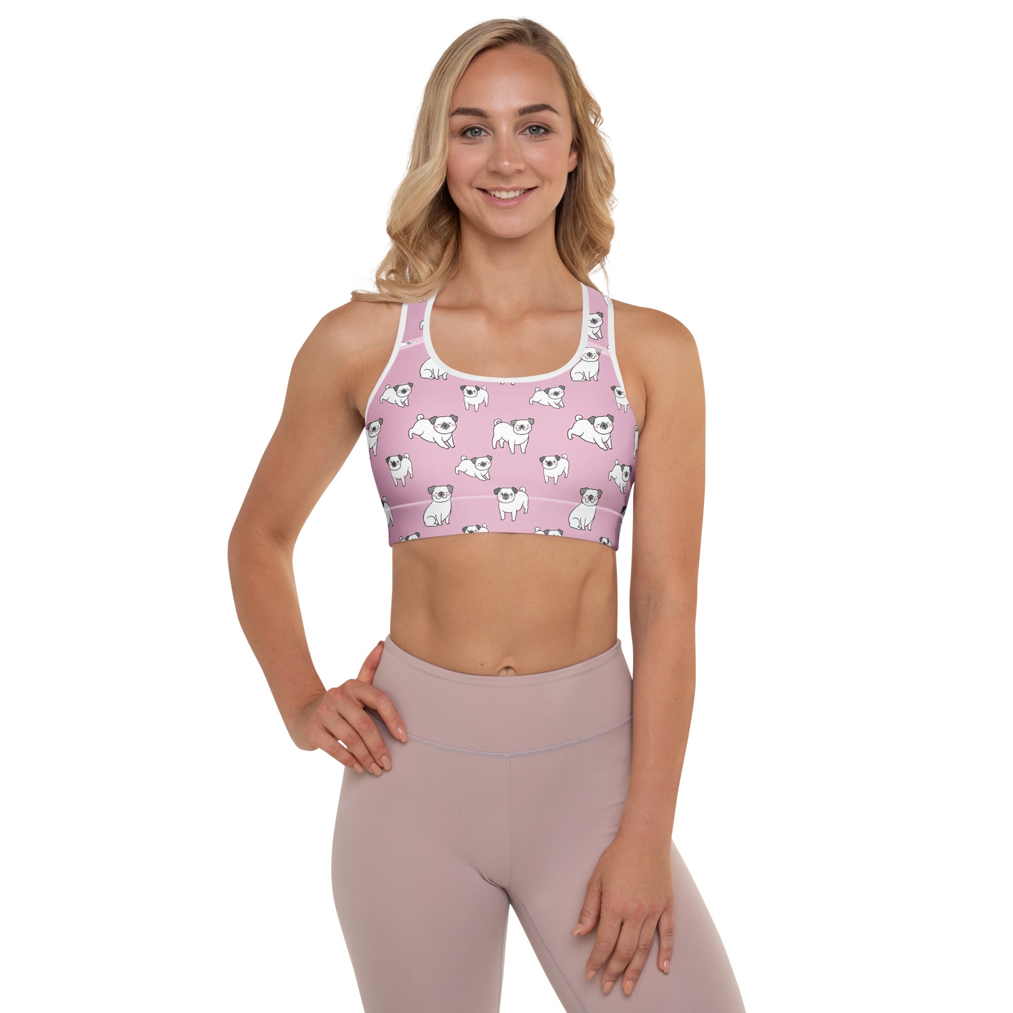 Women’s pink padded sports bra with white pug illustrations and trim made of buttery soft quick-dry fabric