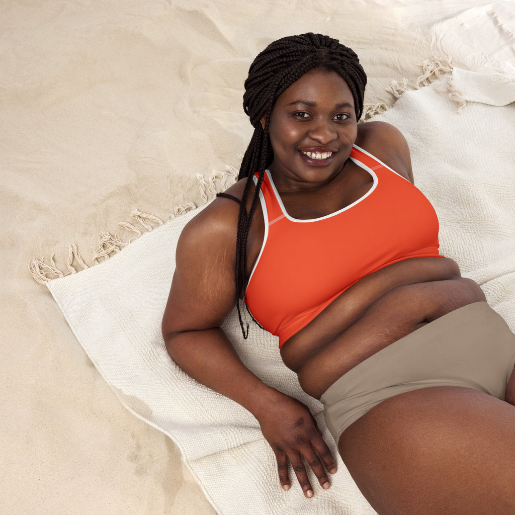 Women’s orange padded sports bra with white trim featuring buttery soft fabric supportive fit and quick-dry material