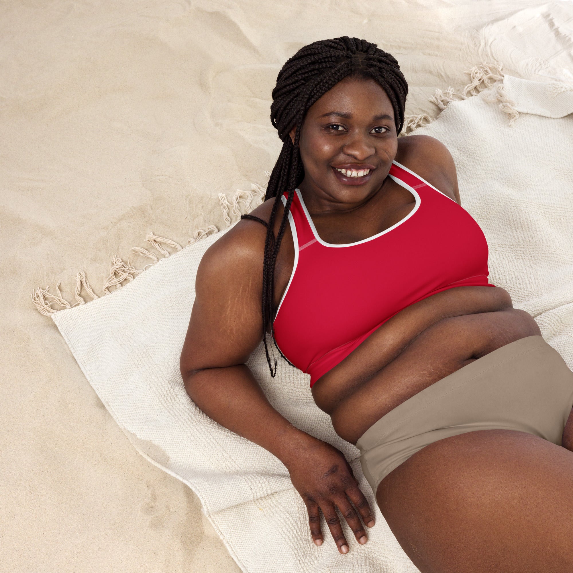 A woman wearing a women’s crimson red padded sports bra with white trim made of buttery soft quick-dry fabric