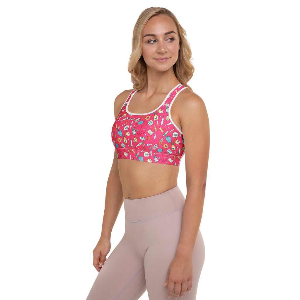 Women’s nurse padded sports bra in pink with white trim featuring medical icons, buttery soft, supportive, and quick-dry