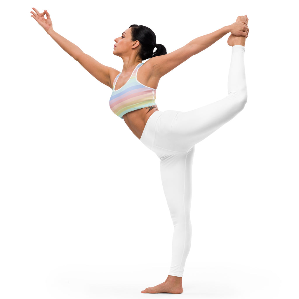 The woman is wearing a women’s striped pastel rainbow padded sports bra that is buttery soft supportive and quick-dry