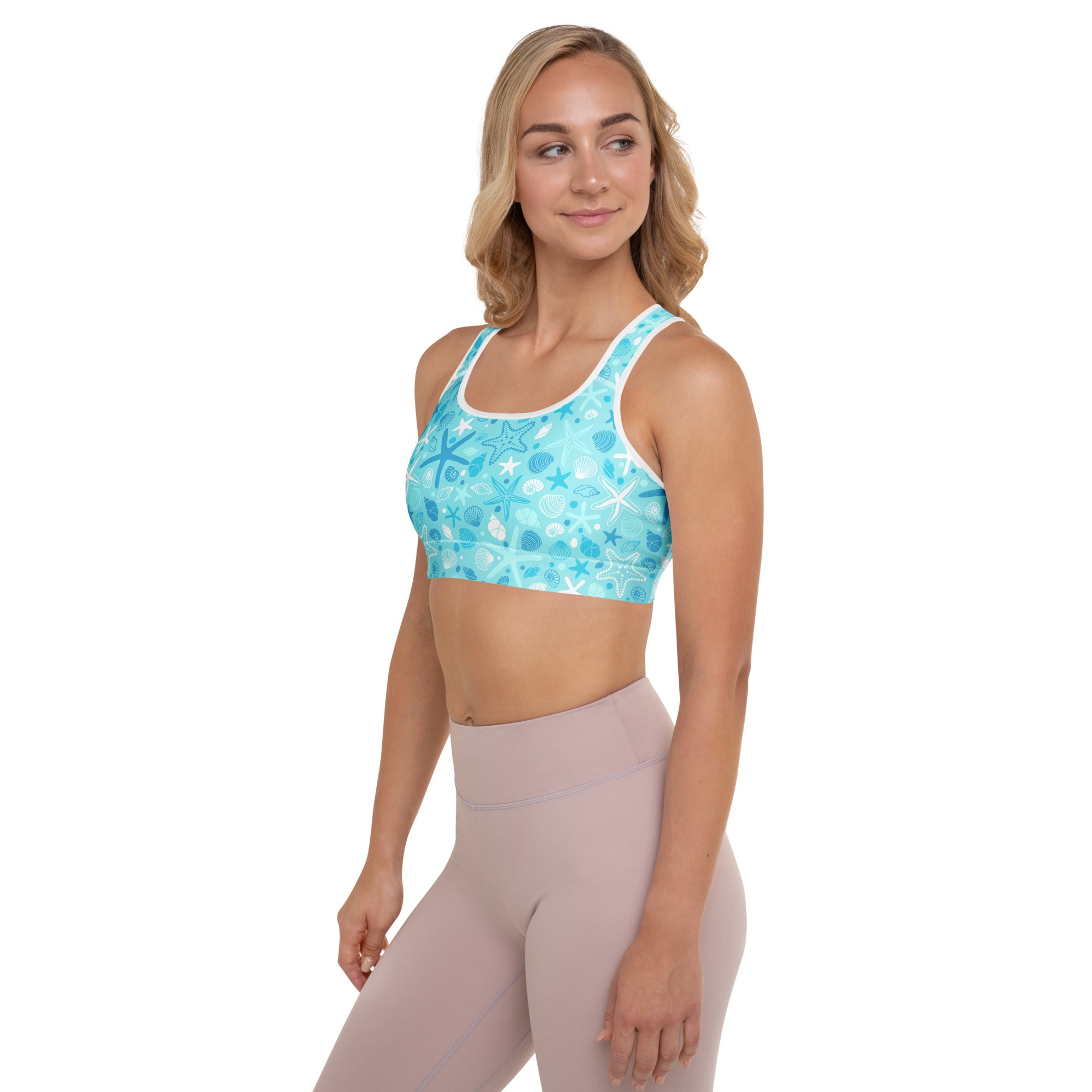A light blue women’s starfish and shells padded sports bra with a playful ocean pattern, buttery soft and quick-dry