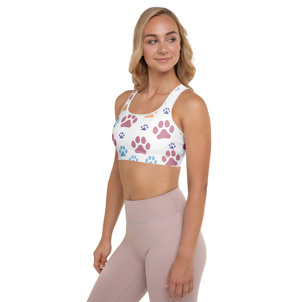White padded women’s sports bra with multicolored pink purple and blue paw prints, buttery soft, supportive, quick-dry