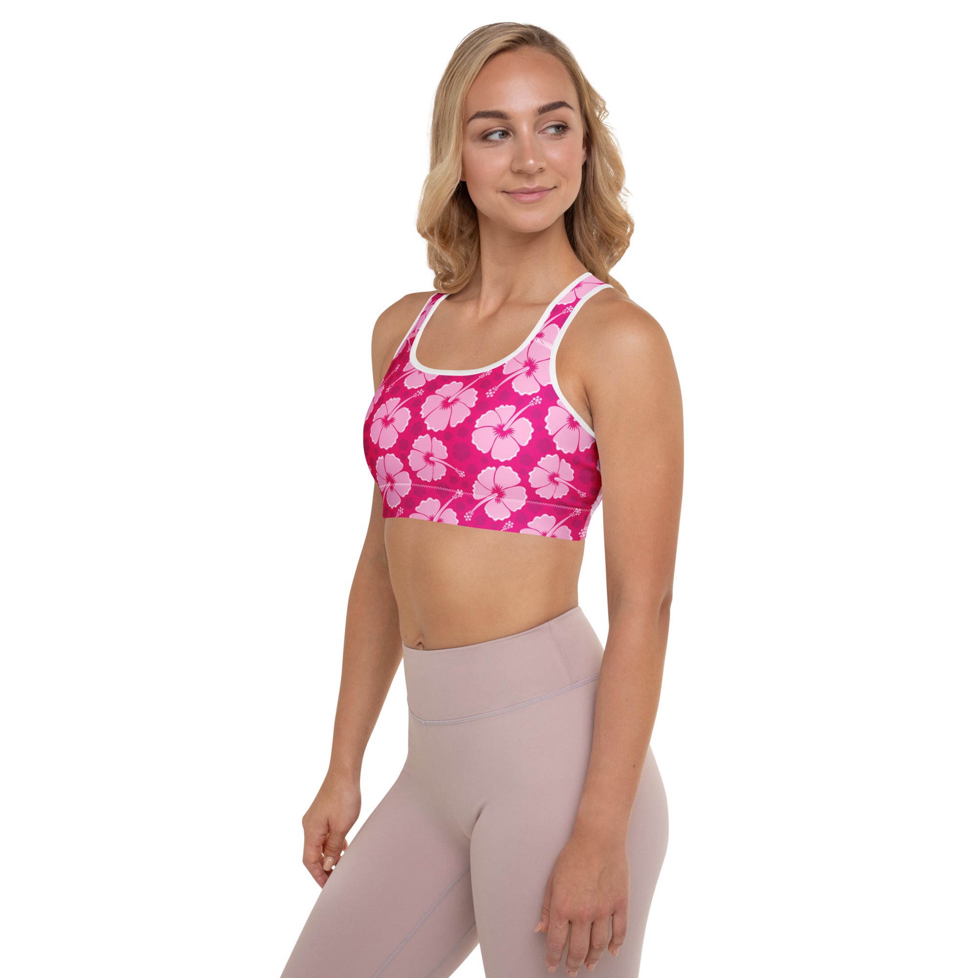 Women’s pink hibiscus floral padded sports bra with white trim, buttery soft, supportive, and quick-dry material