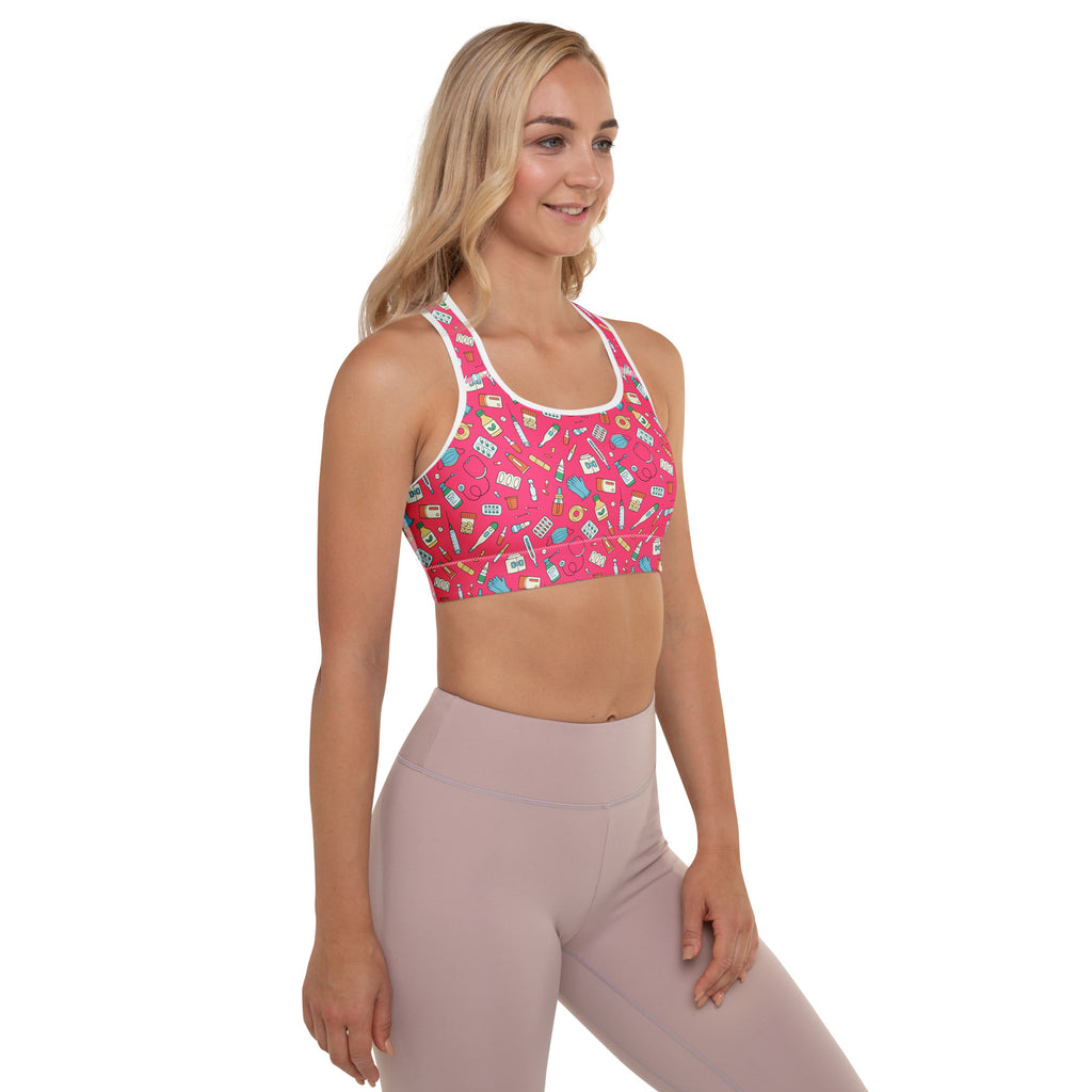 Women’s nurse padded sports bra in pink with white trim featuring colorful school supplies pattern, buttery soft and quick dry