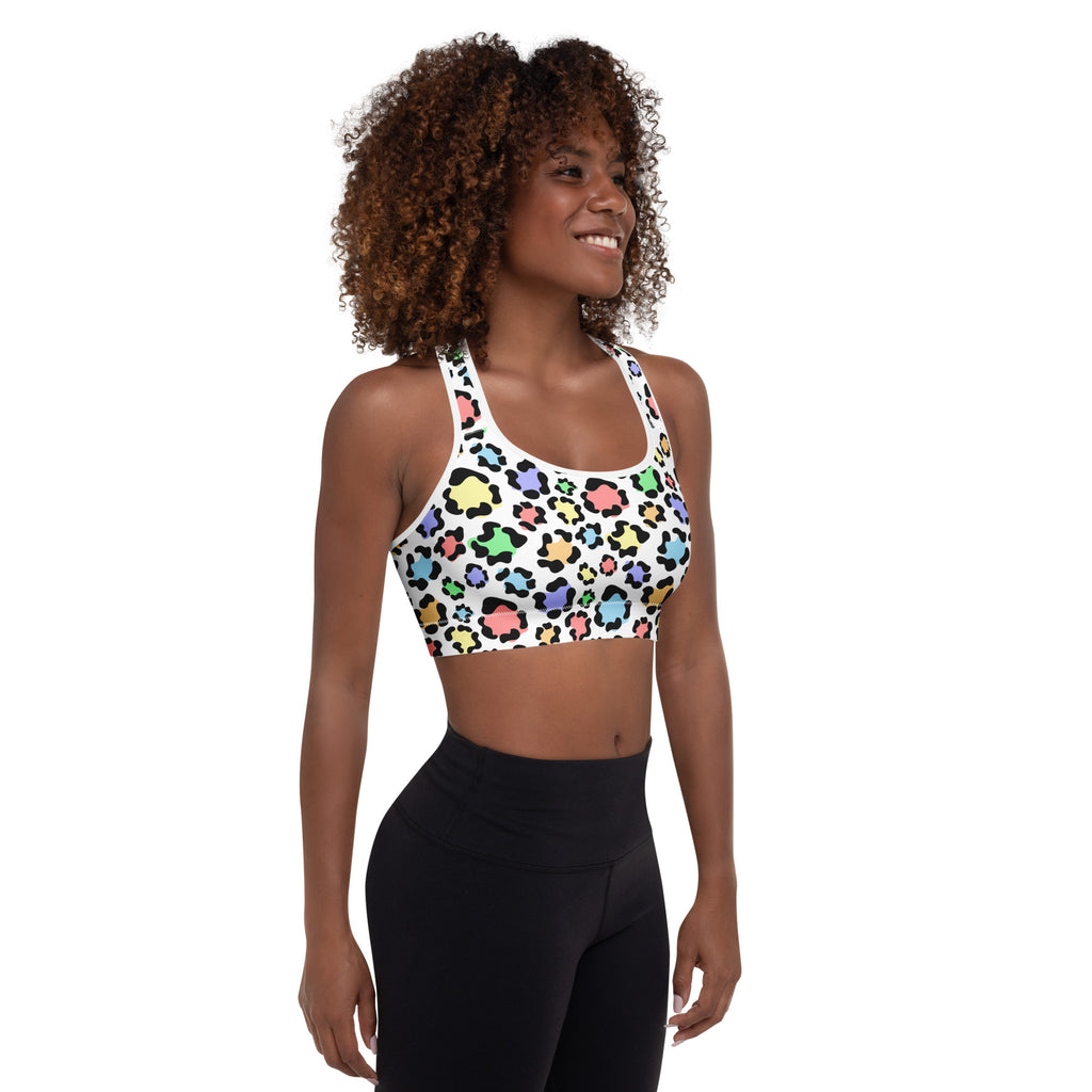 White women’s sports bra with colorful rainbow leopard print, padded, buttery soft, supportive, and quick-dry material