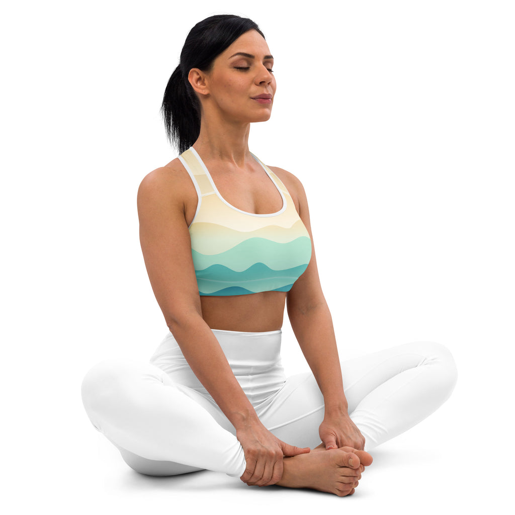 A woman wears a pastel ocean wave padded sports bra with gradient pattern and buttery soft stretchy fabric