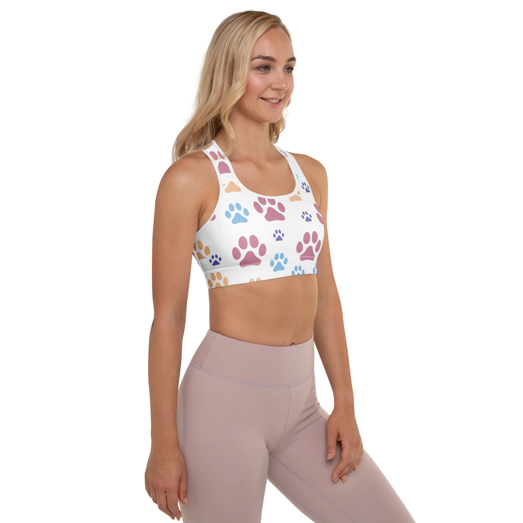 White padded sports bra with colorful blue pink and beige paw prints buttery soft supportive quick-dry fabric