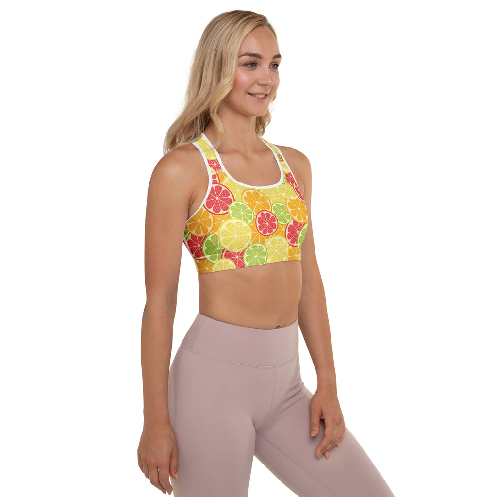 Women’s citrus slice padded sports bra with vibrant orange lemon lime pattern on sunny yellow buttery soft quick-dry fabric