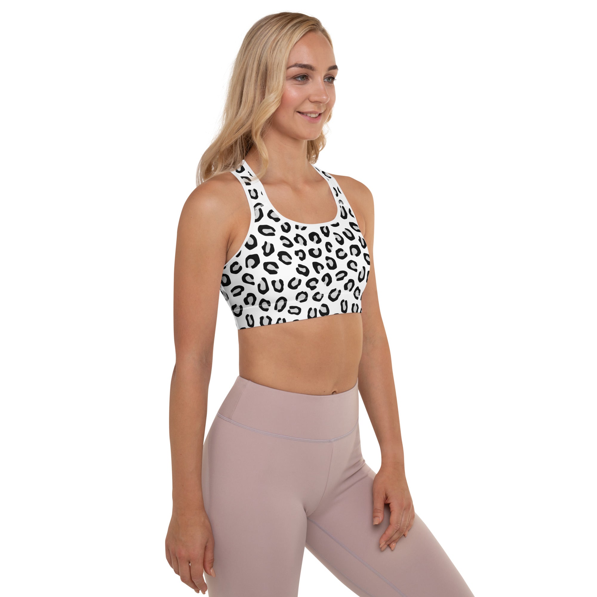 White sports bra with black leopard print pattern featuring padded support buttery soft quick-dry fabric