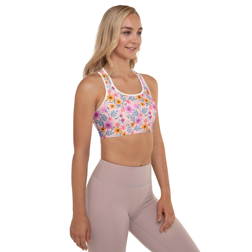 Women’s pink floral print padded sports bra with white trim colorful blossoms buttery soft supportive quick dry